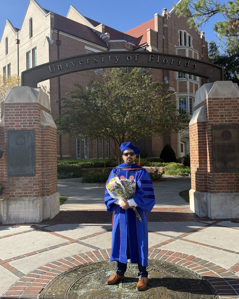 Dr. Utsab Ghimire at the University of Florida arch on graduation day